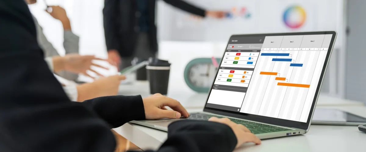 Team reviewing a project timeline on a laptop