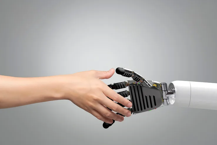 A human hand meeting a robotic hand